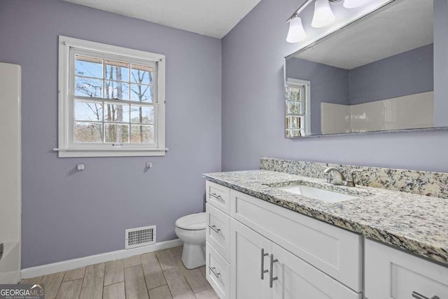 bathroom featuring vanity and toilet