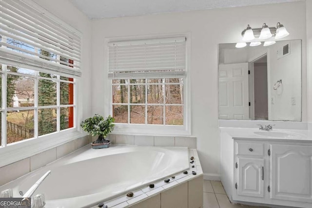 bathroom featuring tile patterned flooring, vanity, and a bathing tub