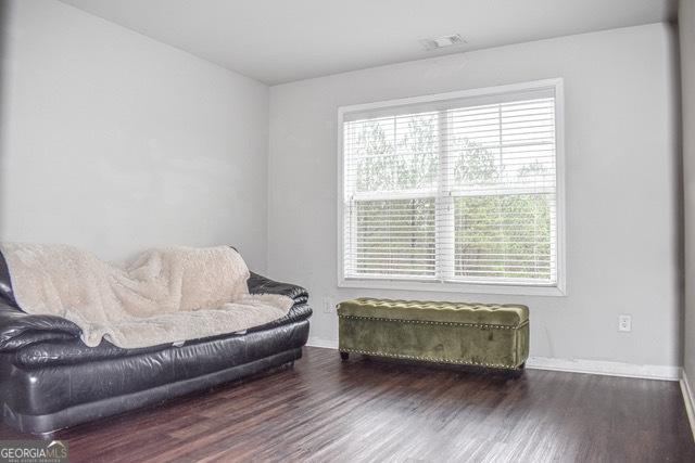 sitting room with dark wood-type flooring