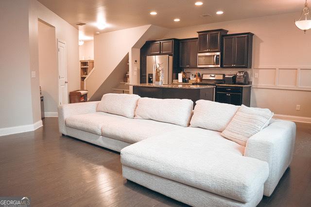 living room featuring dark wood-type flooring