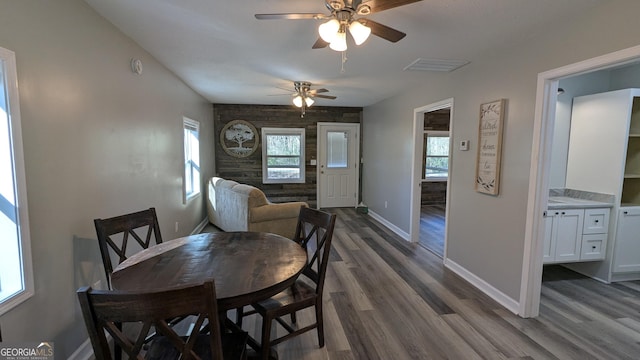 dining area with ceiling fan and dark hardwood / wood-style floors