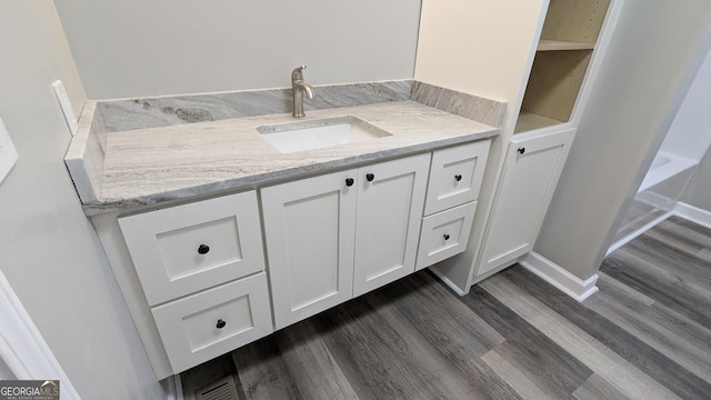 bathroom featuring vanity and wood-type flooring