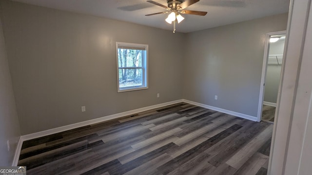 empty room featuring dark hardwood / wood-style floors and ceiling fan