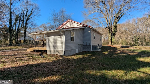 view of side of property with cooling unit and a yard