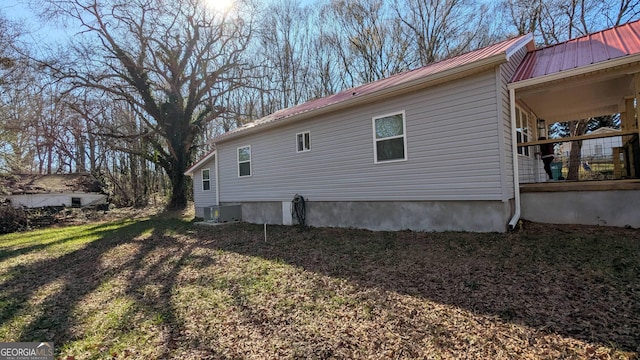 view of side of home featuring central AC unit