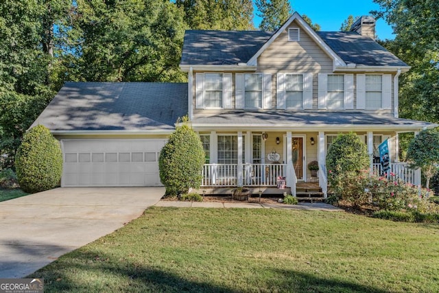 view of front of house with a front yard, a porch, and a garage