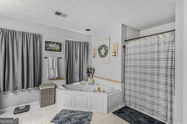 bathroom with a bath and a textured ceiling