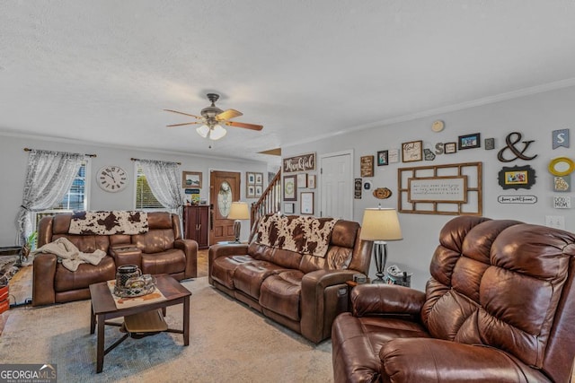 living room with crown molding, ceiling fan, light carpet, and a textured ceiling