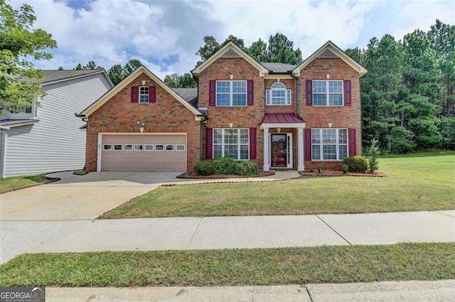 view of front of property featuring a garage and a front lawn