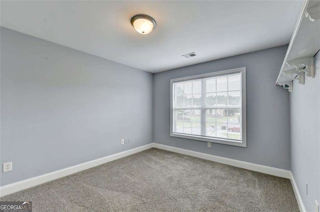 unfurnished room featuring carpet