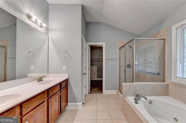 bathroom featuring a healthy amount of sunlight, tile patterned flooring, separate shower and tub, vaulted ceiling, and vanity