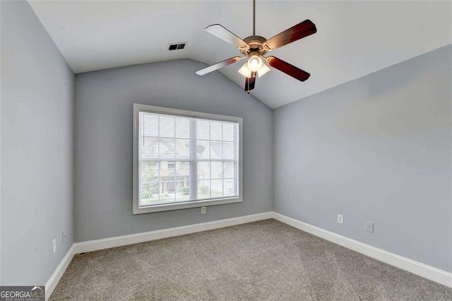 carpeted empty room featuring ceiling fan and lofted ceiling