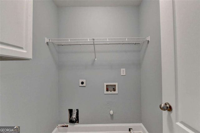 laundry room with washer hookup, hookup for an electric dryer, gas dryer hookup, and cabinets