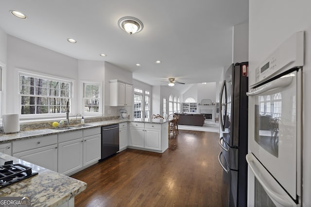 kitchen featuring white cabinets, stainless steel appliances, kitchen peninsula, and ceiling fan