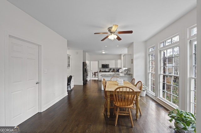 dining room featuring ceiling fan, plenty of natural light, and dark hardwood / wood-style floors