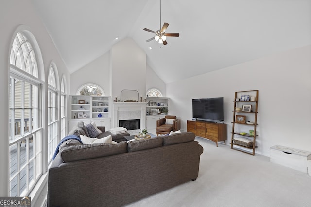 living room featuring light carpet, high vaulted ceiling, and ceiling fan