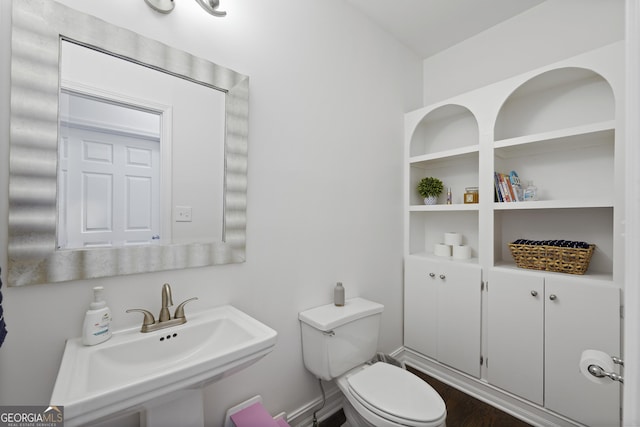 bathroom with sink, wood-type flooring, and toilet