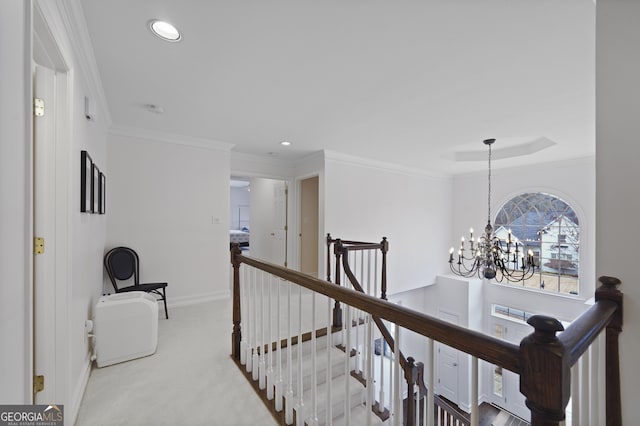 hall with light colored carpet, crown molding, and a chandelier