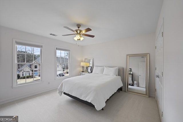 bedroom with light colored carpet and ceiling fan