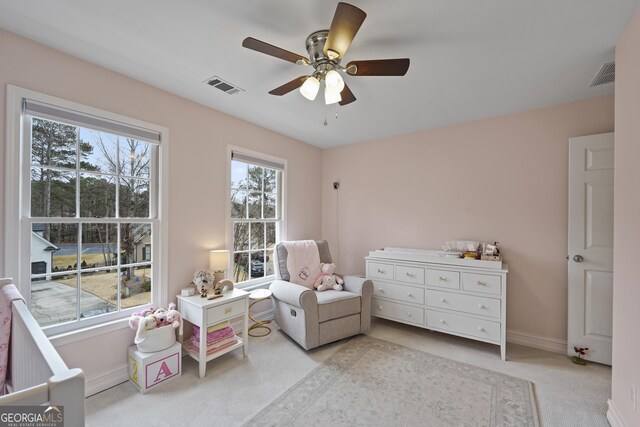 sitting room featuring ceiling fan and light carpet