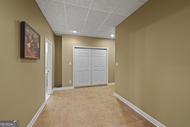 hallway featuring a paneled ceiling