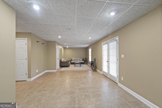 unfurnished room featuring french doors and a paneled ceiling