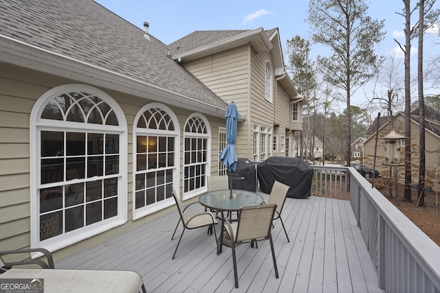 wooden terrace with a grill