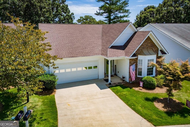 view of front of property with a front yard and a garage