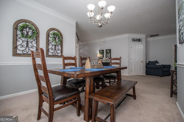 carpeted dining area with a notable chandelier, ornamental molding, and a textured ceiling