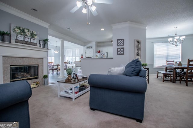 living room with a fireplace, ceiling fan with notable chandelier, light colored carpet, and a wealth of natural light