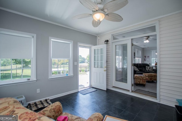 doorway to outside with ceiling fan and ornamental molding