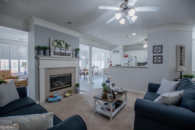 carpeted living room with a tile fireplace, ceiling fan, and a textured ceiling