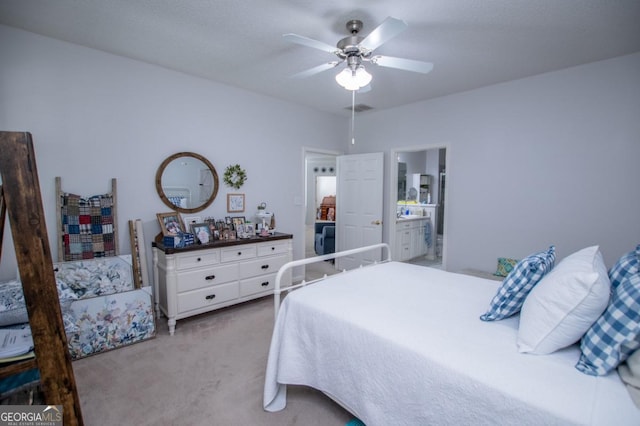 bedroom with ceiling fan, carpet floors, and ensuite bath