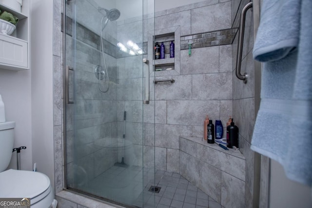 bathroom featuring an enclosed shower and toilet