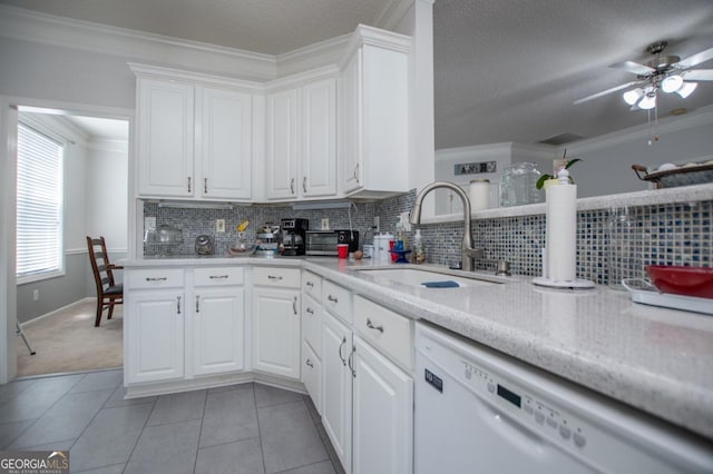 kitchen featuring white cabinets, tasteful backsplash, ornamental molding, sink, and dishwasher