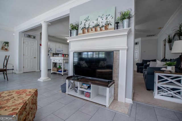 living room featuring ornate columns, light tile patterned flooring, and ornamental molding