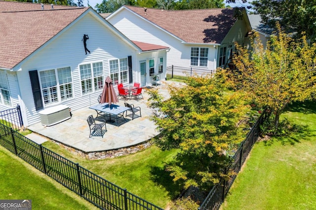 rear view of property with a patio area and a lawn