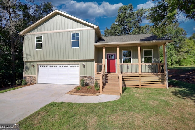 tri-level home featuring a front yard, a porch, and a garage