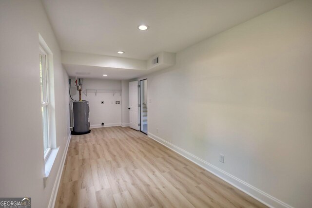 interior space with water heater and light hardwood / wood-style floors