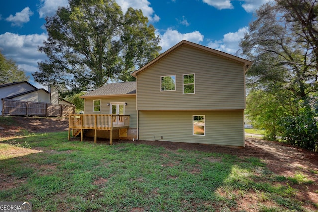 rear view of property featuring a deck and a yard