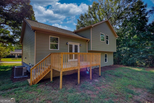 back of house featuring cooling unit, a deck, a yard, and french doors