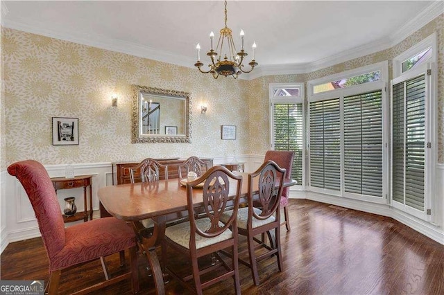 dining space featuring dark hardwood / wood-style flooring, an inviting chandelier, and ornamental molding