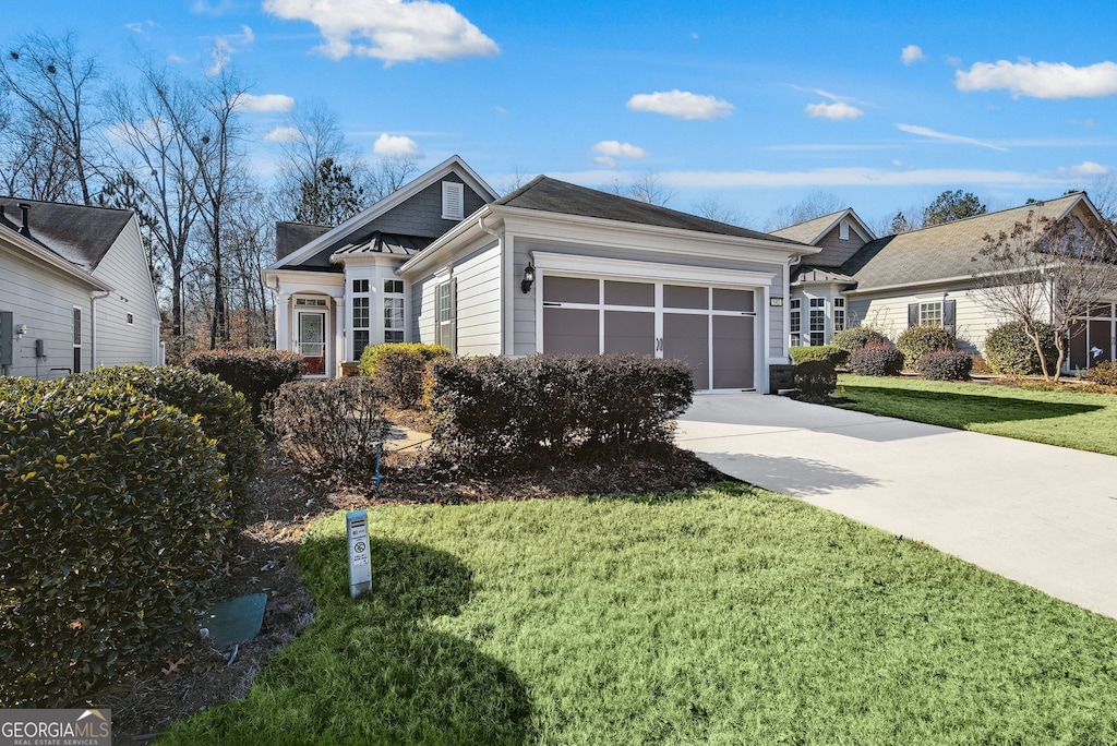 view of front of home featuring a front yard and a garage