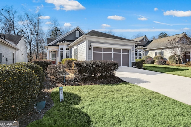 view of front of home featuring a front yard and a garage