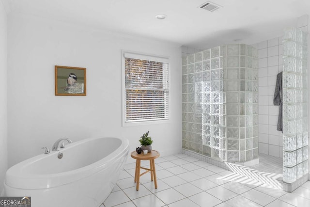 bathroom featuring tile patterned flooring and separate shower and tub