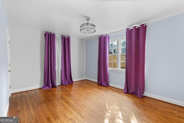 empty room with hardwood / wood-style floors