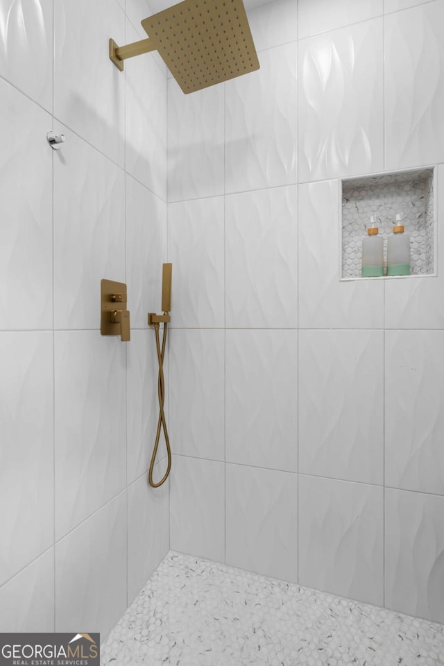 bathroom with a tile shower