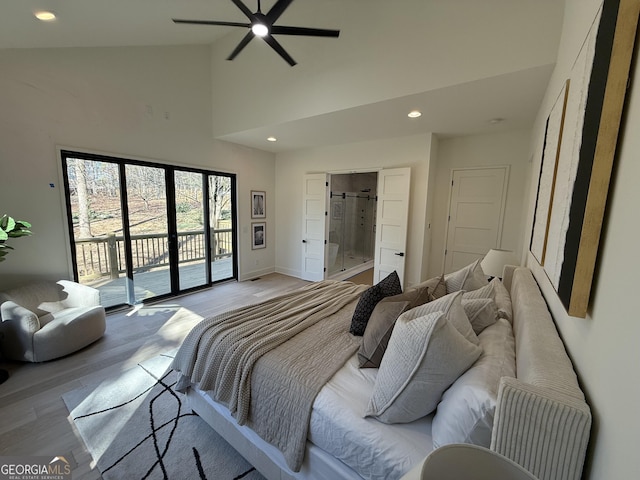 bedroom with ensuite bath, vaulted ceiling, light wood-type flooring, ceiling fan, and access to exterior