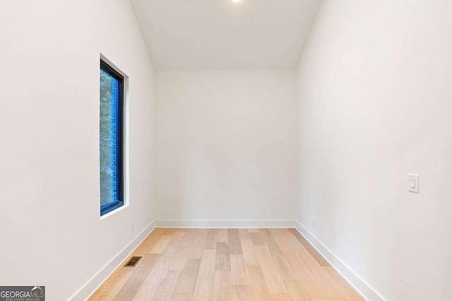 empty room with light hardwood / wood-style flooring