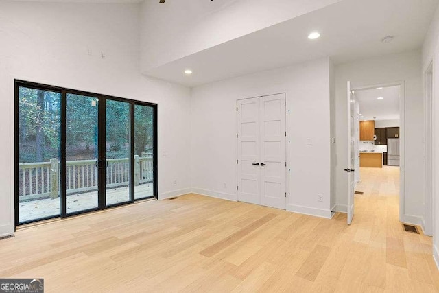 spare room with light wood-type flooring